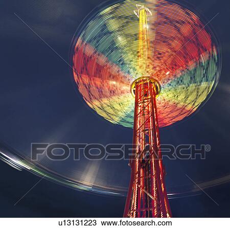 Illuminated chairoplane against dark sky View Large Photo Image Stock Image - Illuminated chairoplane against dark sky. Fotosearch