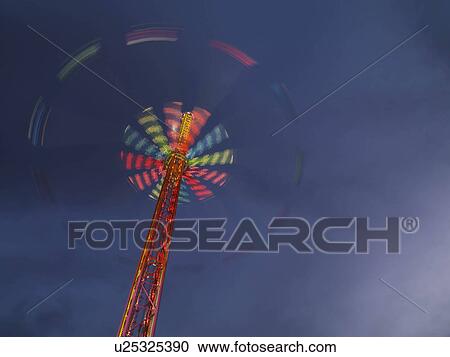 Illuminated chairoplane against dark sky View Large Photo Image Stock Image - Illuminated chairoplane against dark sky. Fotosearch