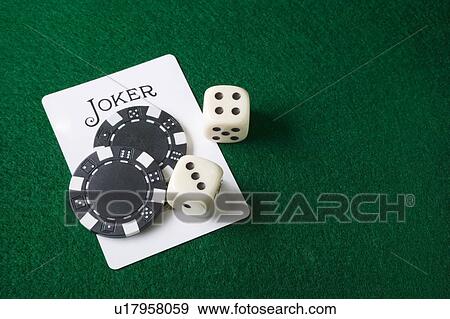 Stock Photo - Joker card and gambling chips and dice. Fotosearch