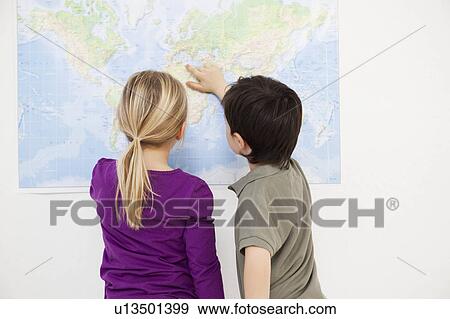 Stock Photo - kids looking at world map. Fotosearch