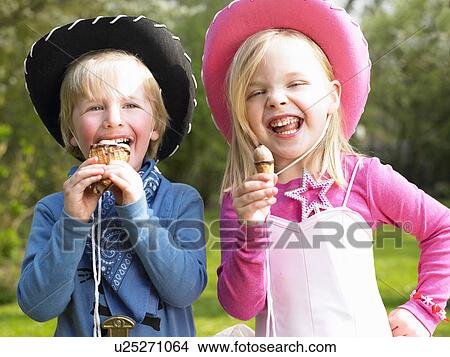 Picture - Kids with costume, eating ice-cream. Fotosearch