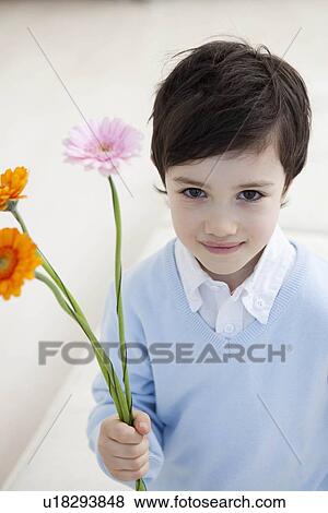Stock Photo - little boy with flowers. Fotosearch
