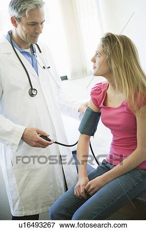 Male Doctor examining girl patient View Large Photo Image Stock Photo - Male Doctor examining girl patient. Fotosearch