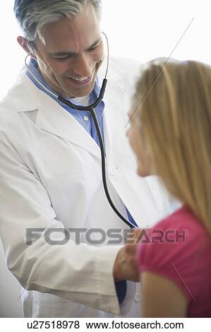 Stock Photo - Male Doctor examining girl patient. Fotosearch