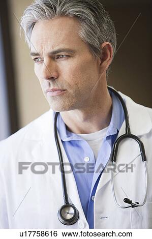 Male Doctor looking out window thinking View Large Photo Image Stock Photograph - Male Doctor looking out window thinking. Fotosearch