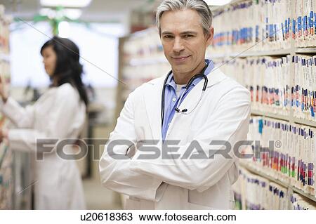 Male Doctor smiling with female doctor View Large Photo Image Stock Image - Male Doctor smiling with female doctor. Fotosearch