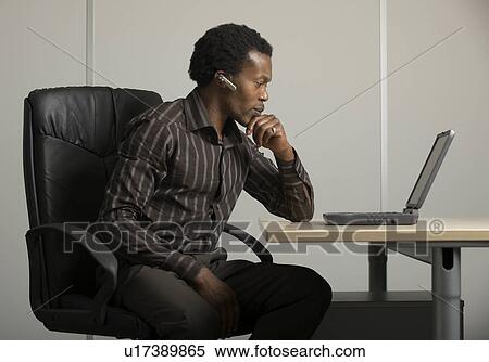 male worker at desk View Large Photo Image Stock Photography - male worker at desk. Fotosearch