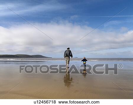 man and child walking towards sea View Large Photo Image Stock Photo - man and child walking towards sea. Fotosearch
