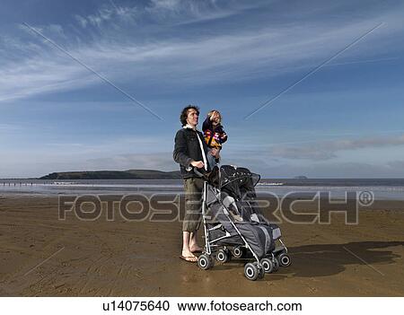 man at beach with pushchair and child View Large Photo Image Stock Image - man at beach with pushchair and child. Fotosearch