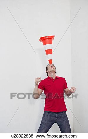 Stock Photo - man balancing a pylon on his head. Fotosearch