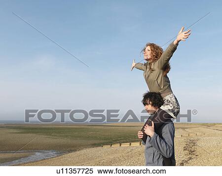 Man carrying woman on shoulders View Large Photo Image Stock Photography - Man carrying woman on shoulders. Fotosearch