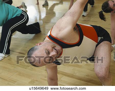 Stock Photo - man doing aerobic exercise at gym. Fotosearch