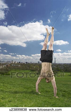 Stock Photo - man doing hand stand. Fotosearch