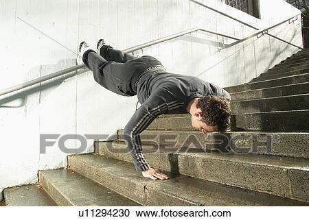 Stock Image - man doing press ups. Fotosearch
