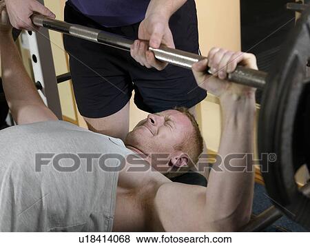 man exercising with weights at gym View Large Photo Image Stock Photo - man exercising with weights at gym. Fotosearch