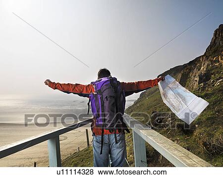 man hiking on cliff edge View Large Photo Image Stock Photo - man hiking on cliff edge. Fotosearch