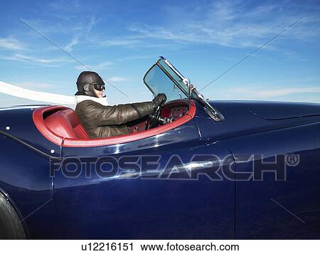 Stock Image - Man in an old convertible. Fotosearch