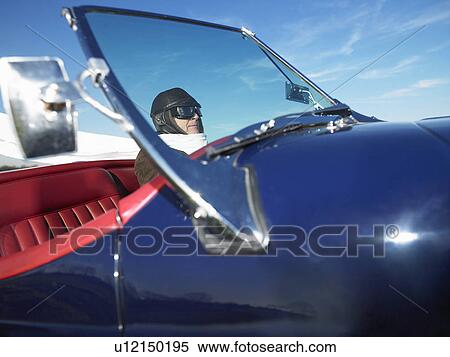 Stock Photography - Man in an old convertible. Fotosearch