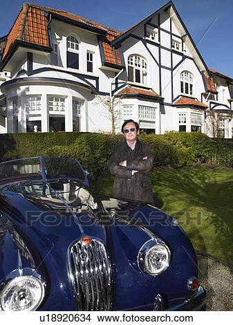 Picture - Man in front of his house and car. Fotosearch