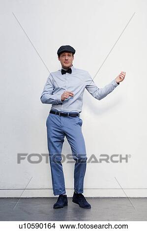 man in front of white wall dancing View Large Photo Image Picture - man in front of white wall dancing. Fotosearch