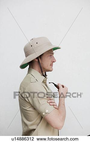 Stock Image - man in jungle outfit holding pipe. Fotosearch
