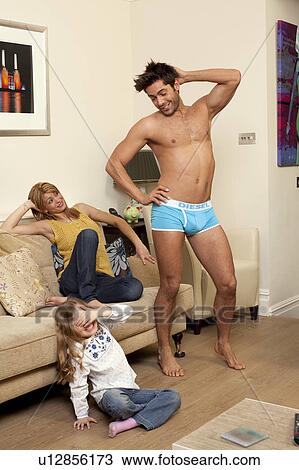 man in underwear showing off to family View Large Photo Image Stock Image - man in underwear showing off to family. Fotosearch
