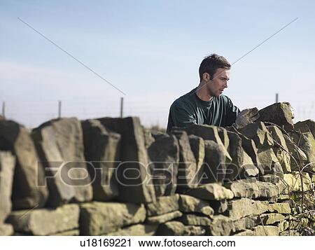 Man Inspecting Dry Stone Wall View Large Photo Image Stock Image - Man Inspecting Dry Stone Wall. Fotosearch