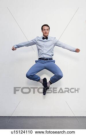 Stock Image - man jumping in the air. Fotosearch