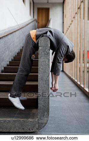 Stock Photograph - man leaning over on railing. Fotosearch