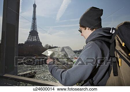 Man looking on the map near eiffel tower View Large Photo Image Picture - Man looking on the map near eiffel tower. Fotosearch