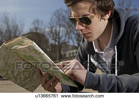 Stock Image - Man looking on the map. Fotosearch