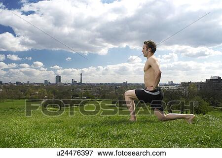 Stock Photo - man lunging in park. Fotosearch