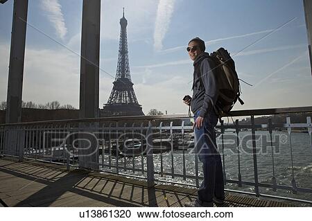 Stock Image - Man near eiffel tower. Fotosearch
