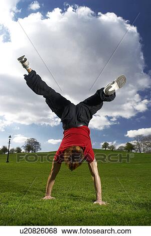 man performing handstand in park View Large Photo Image Stock Photo - man performing handstand in park. Fotosearch