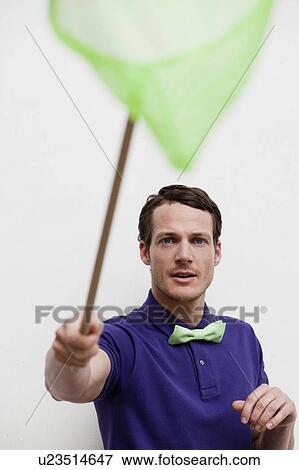 Stock Photo - man playing with butterfly net. Fotosearch