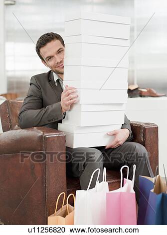 man shopping holding pile of cartons View Large Photo Image Stock Image - man shopping holding pile of cartons. Fotosearch