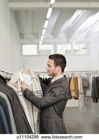 man shopping looking at jackets View Large Photo Image Stock Photo - man shopping looking at jackets. Fotosearch
