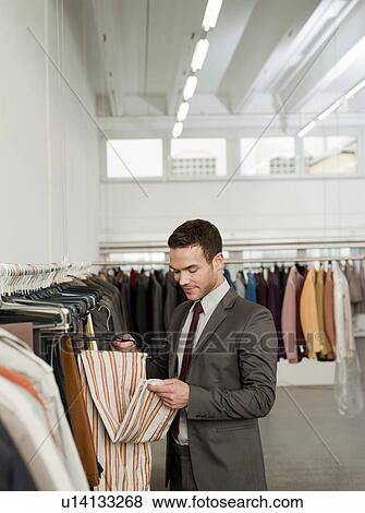 man shopping looking at jackets View Large Photo Image Stock Photo - man shopping looking at jackets. Fotosearch