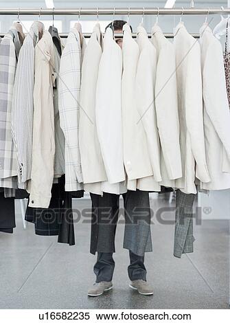 man shopping looking at jackets View Large Photo Image Stock Photography - man shopping looking at jackets. Fotosearch