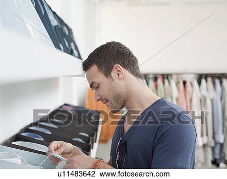 man shopping looking at label View Large Photo Image Stock Image - man shopping looking at label. Fotosearch