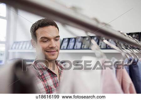 man shopping looking at shirts View Large Photo Image Stock Photo - man shopping looking at shirts. Fotosearch
