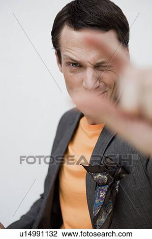 Stock Image - man showing a gesture to viewer. Fotosearch