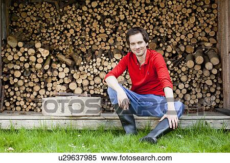 man sitting in front of haystack View Large Photo Image Stock Photography - man sitting in front of haystack. Fotosearch