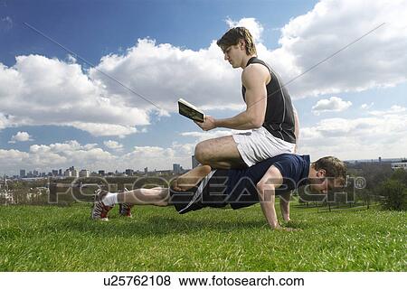 man sitting on friend's back View Large Photo Image Stock Photo - man sitting on friend's back. Fotosearch