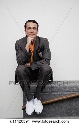 man sitting on railing View Large Photo Image Picture - man sitting on railing. Fotosearch