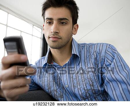 Stock Photo - Man using a mobile phone.. Fotosearch