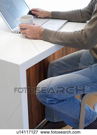 Stock Photo - Man using laptop. Fotosearch