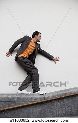 man walking on railing View Large Photo Image Stock Image - man walking on railing. Fotosearch