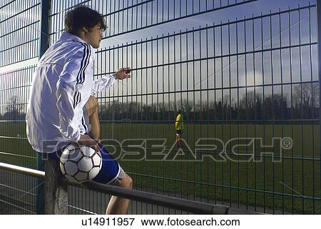 Stock Photo - man watching football. Fotosearch