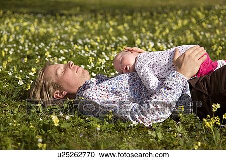man with baby sleeping in grass View Large Photo Image Stock Image - man with baby sleeping in grass. Fotosearch